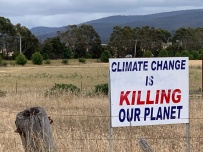 Sign in farmer's field, Tasmania, Australia